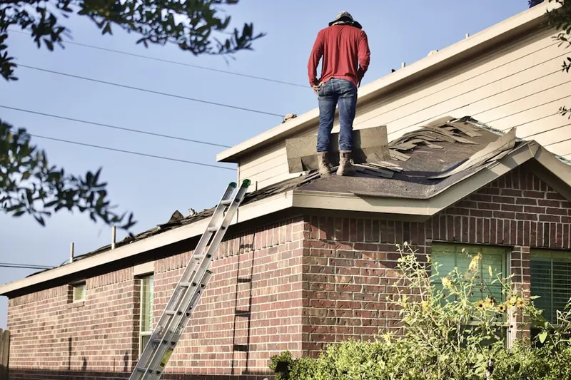Professional roofer working on a residential roof in Massanetta Springs